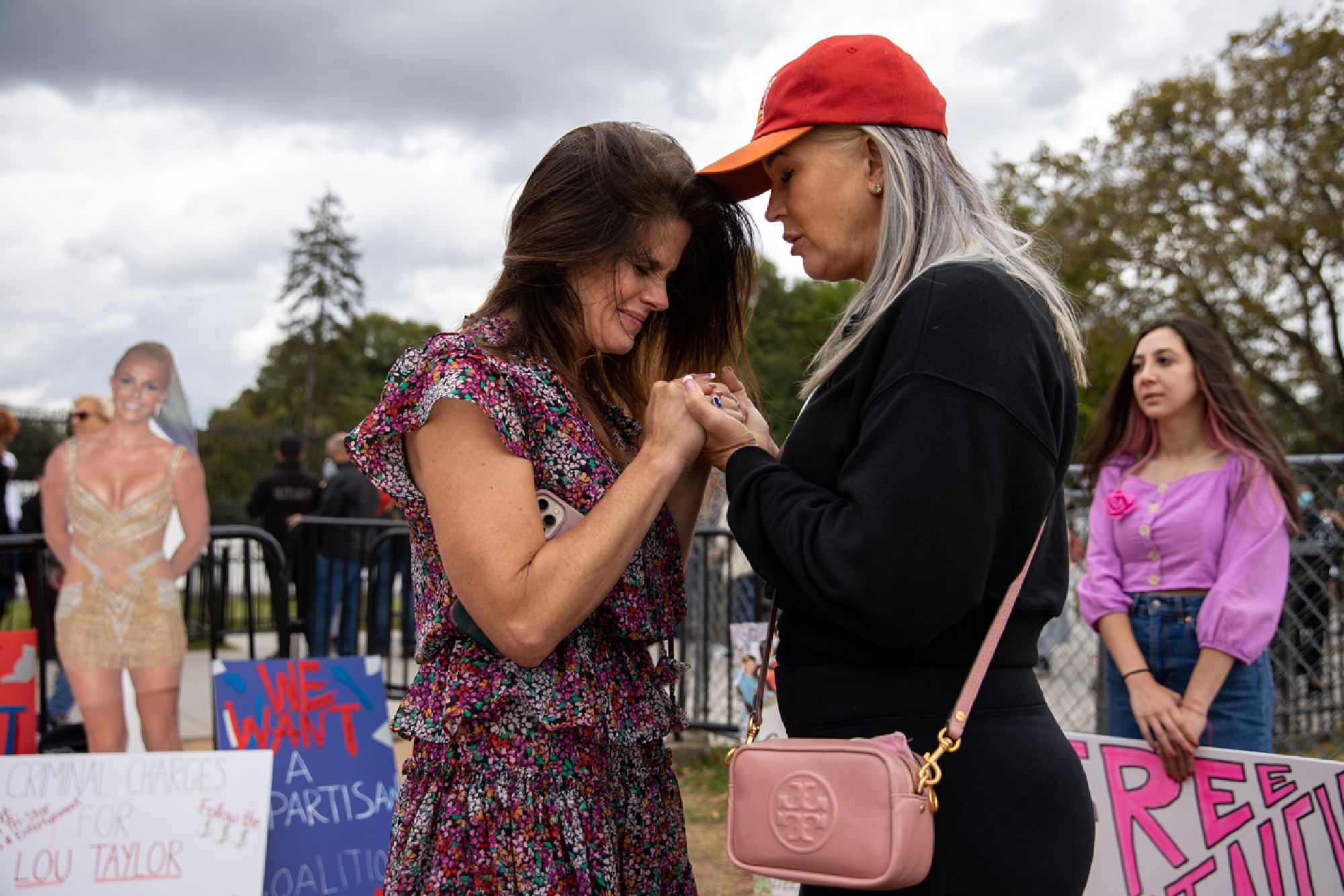 Elizabeth Harding Weinstein, left, prays with Polly Walshin during the "Free Britney" rally in Washington, D.C., on Saturday, Oct. 23, 2021. MUST CREDIT: Photo by Amanda Andrade-Rhoades for The Washington Post
