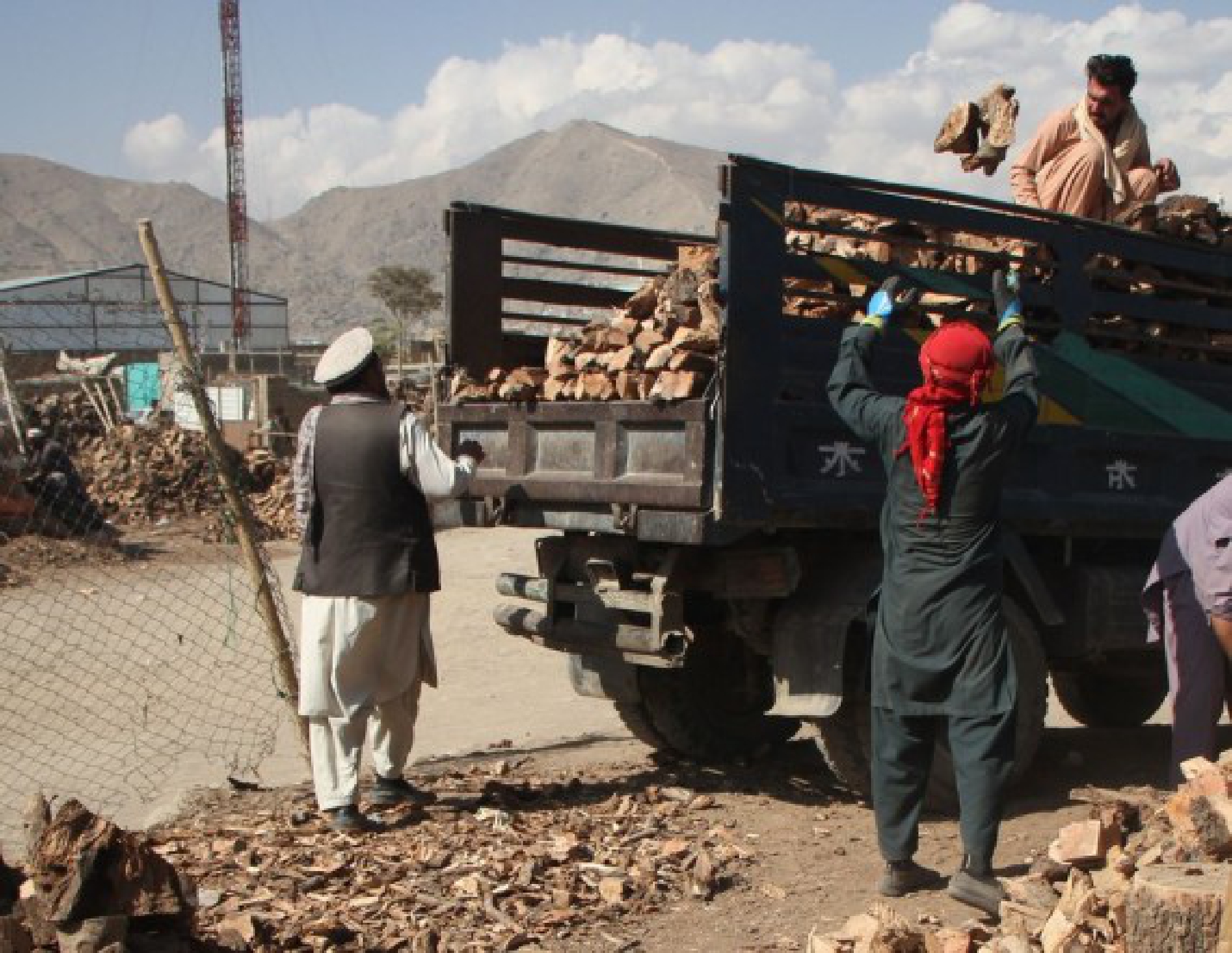 Afghan men work at a wood market in Kabul, Afghanistan, Oct. 17, 2021. (Photo by Saifurahman Safi/Xinhua)