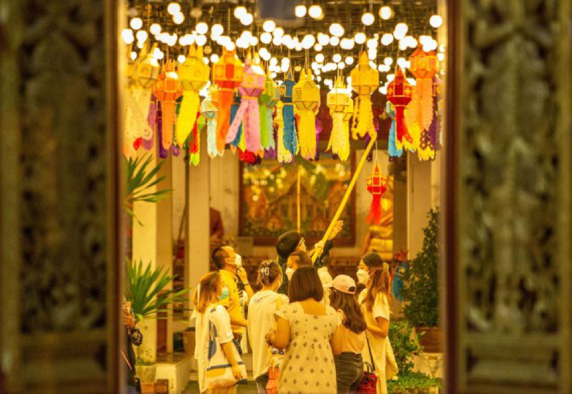 Tourists hang lanterns at the Wat Phra That Hariphunchai in Lamphun, Thailand, Oct. 25, 2021. (Xinhua/Wang Teng)