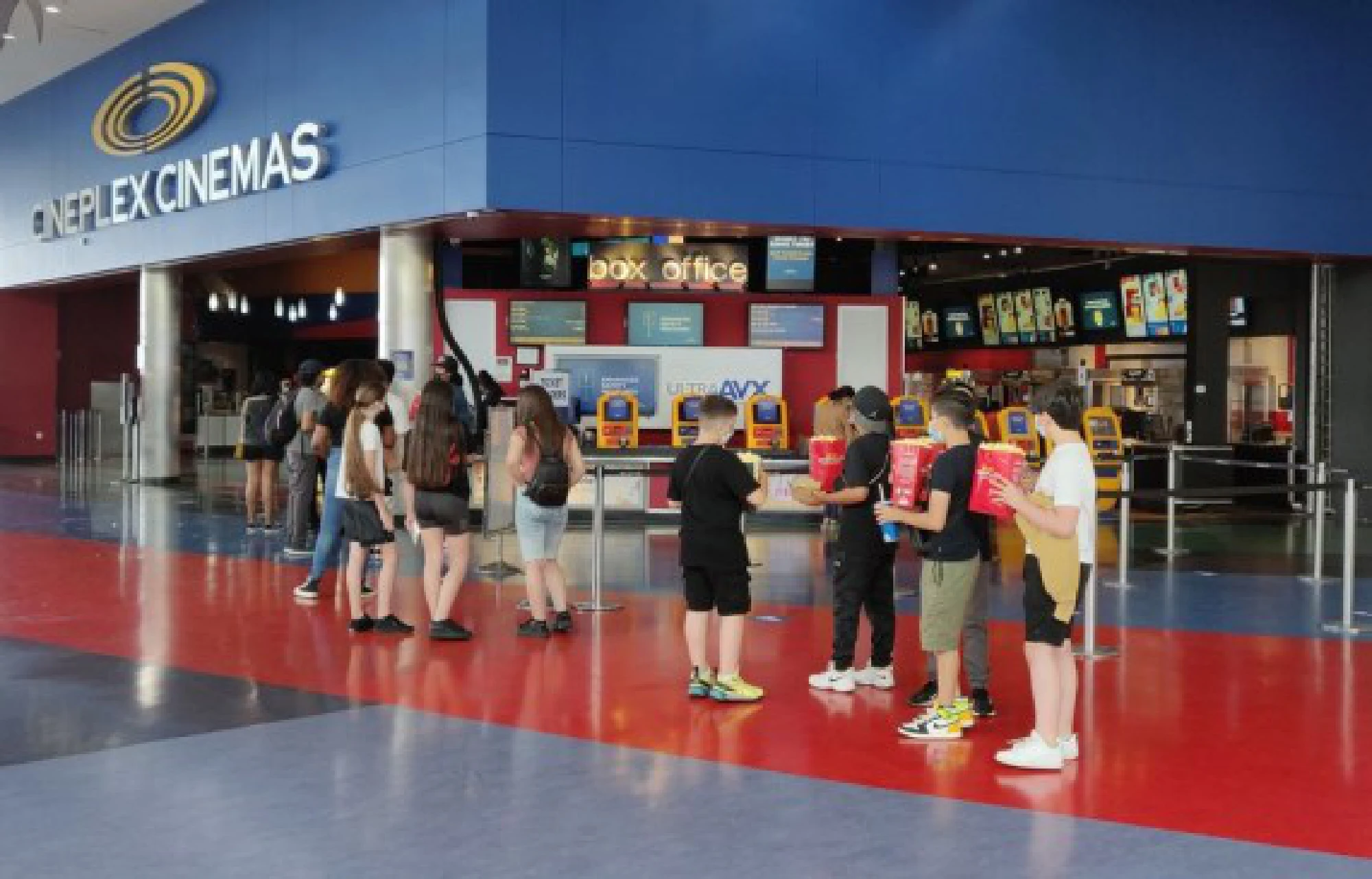 People line up to enter a movie theater in Toronto, Ontario, Canada, on July 16, 2021. (Photo by Zou Zheng/Xinhua)