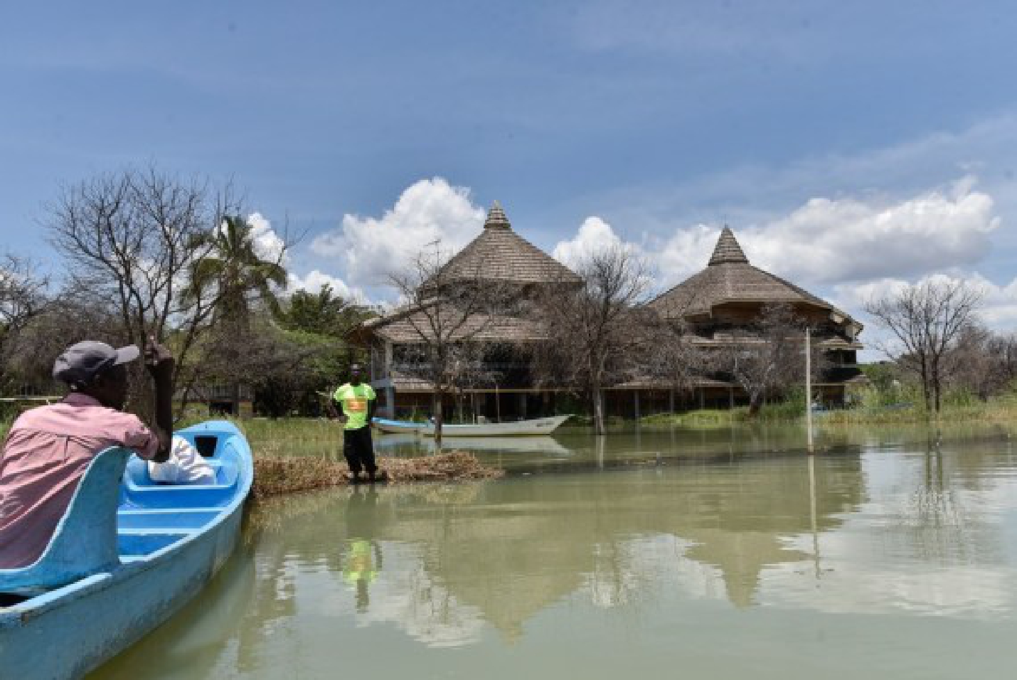 Locals are seen near a submerged hotel facility after the rise in water level in Lake Baringo, Baringo County, Kenya, Oct. 22, 2021. (Xinhua/Sheikh Maina)