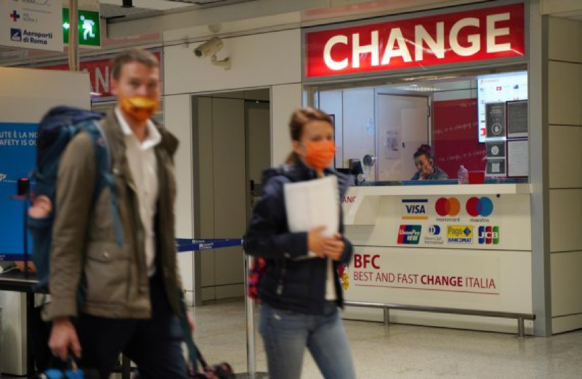 Passengers walk past a money exchange point at the Fiumicino airport in Rome, Italy, on Oct. 2, 2021. (Xinhua/Jin Mamengni)