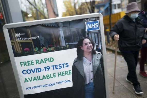 People walk past a sign of free rapid COVID-19 tests in Manchester, Britain, Nov. 10, 2021. (Xinhua/Jon Super)