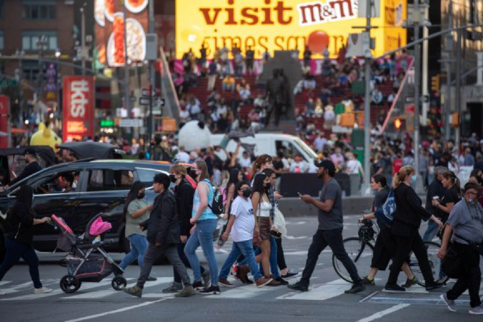 People walk through Times Square in New York, the United States, Oct. 2, 2021. (Photo by Michael Nagle/Xinhua)