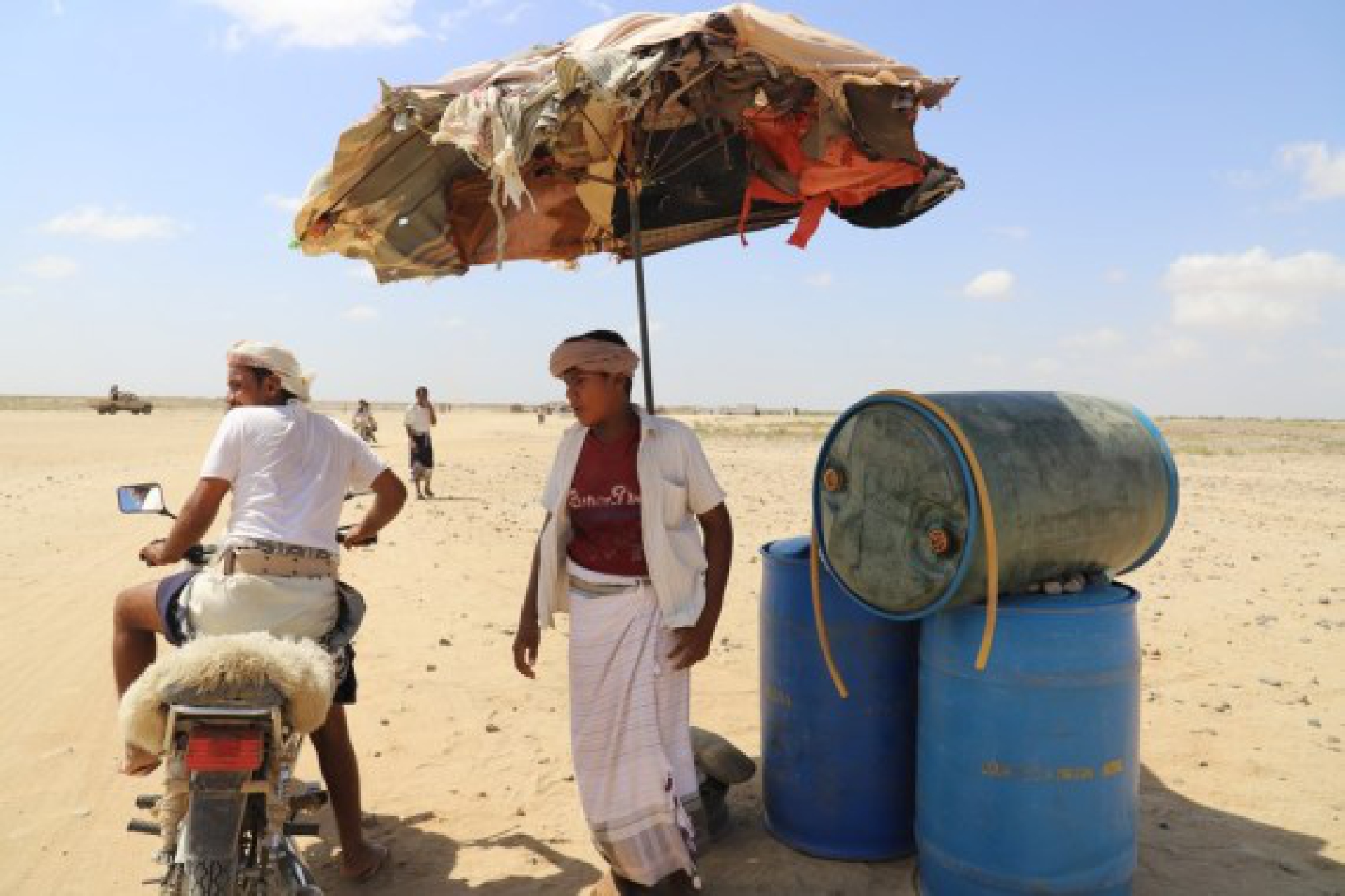 A Yemeni man buys petrol for his motorcycle from a make-shift oil station on Nov. 5, 2021 in Hajjah Province, northern Yemen. (Photo by Mohammed Al-Wafi/Xinhua)
