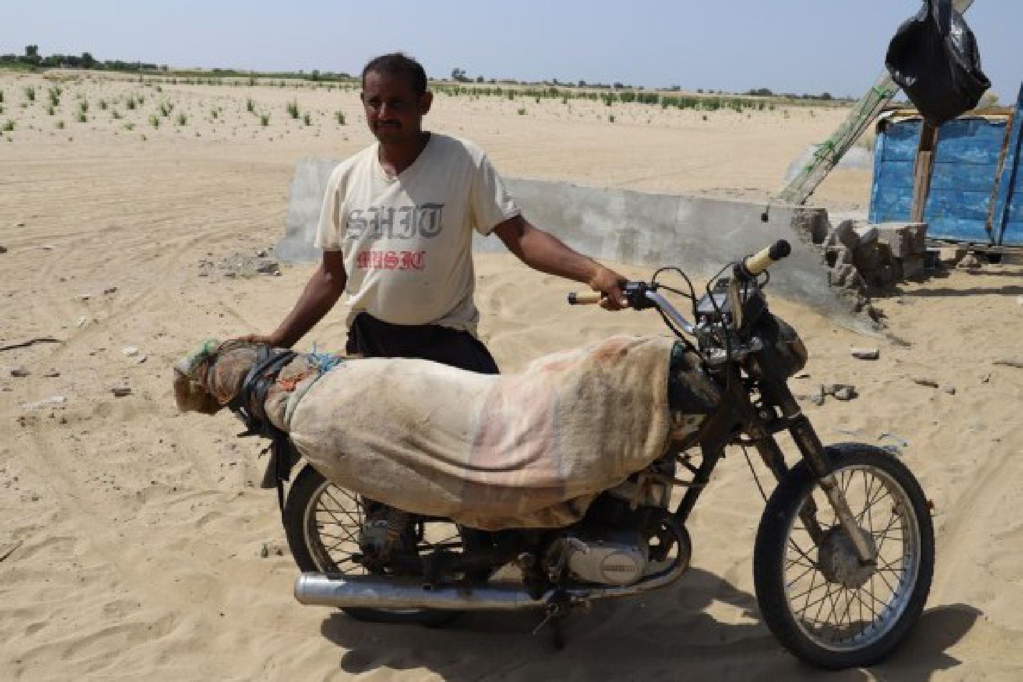 A Yemeni man stands beside his motorcycle on Nov. 5, 2021 in Hajjah Province, northern Yemen. (Photo by Mohammed Al-Wafi/Xinhua)