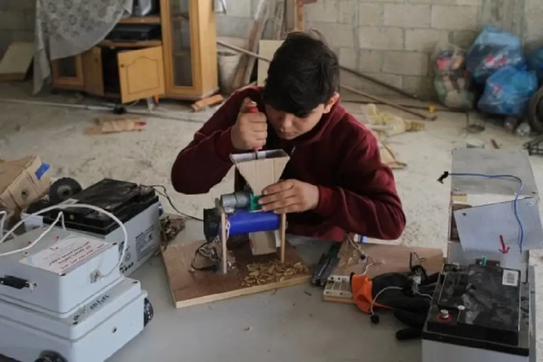 Mohammed al-Halaq works on his inventions at home in the southern Gaza Strip city of Khan Younis, on Nov. 15, 2021. (Xinhua/Rizek Abdeljawad)