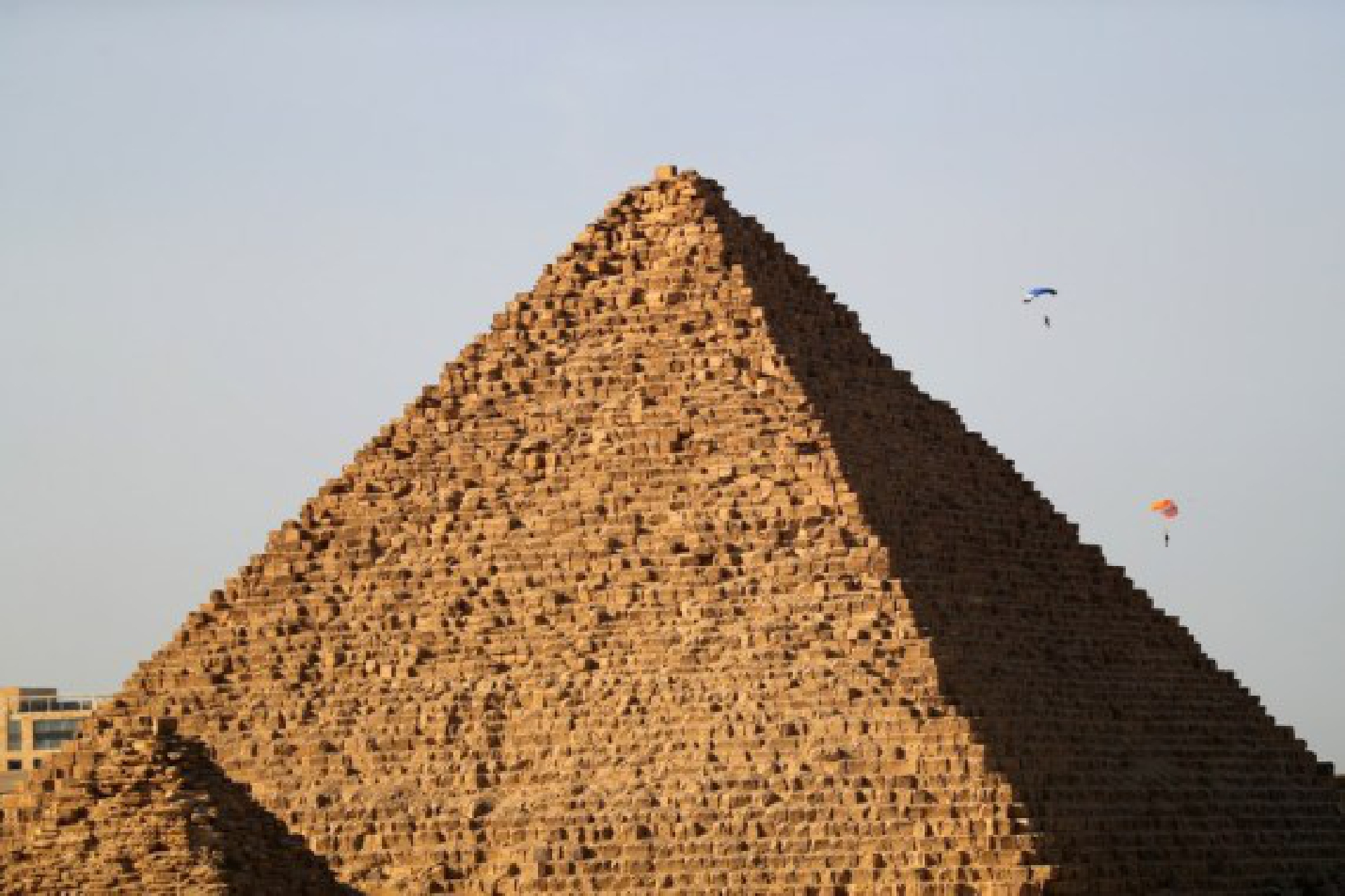 Skydivers fly over the Pyramids during the skydiving festival "Jump Like a Pharaoh" in Giza, Egypt, on Nov. 1, 2021. (Xinhua/Sui Xiankai)