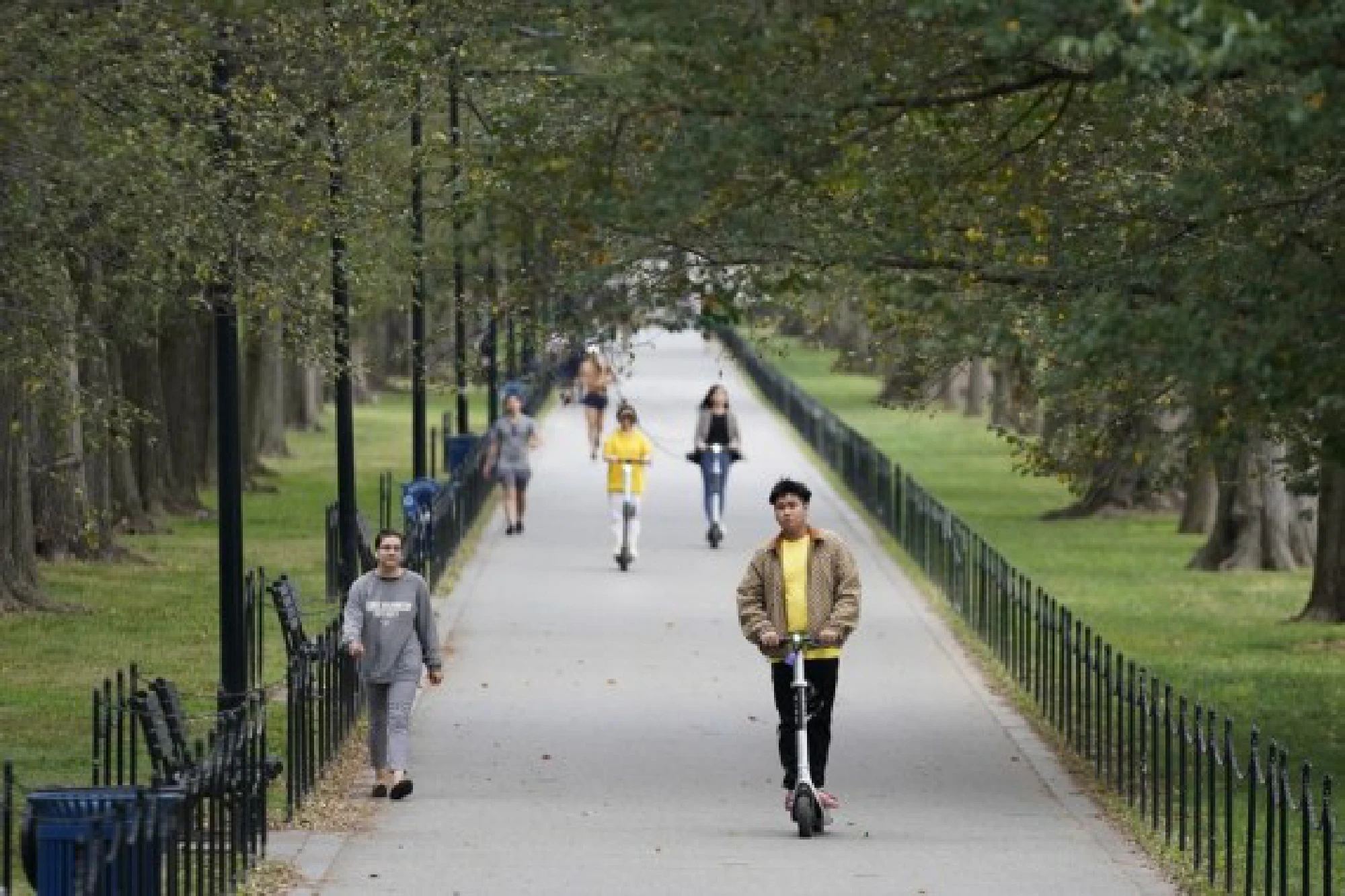 People ride scooters on the National Mall in Washington, D.C., the United States, on Oct. 25, 2021. (Photo by Ting Shen/Xinhua)