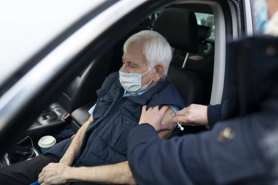 A man receives the second dose of the Pfizer-BioNTech COVID-19 vaccine at Hyde Leisure Centre in Greater Manchester, Britain, on Jan. 7, 2021. (Xinhua/Jon Super)