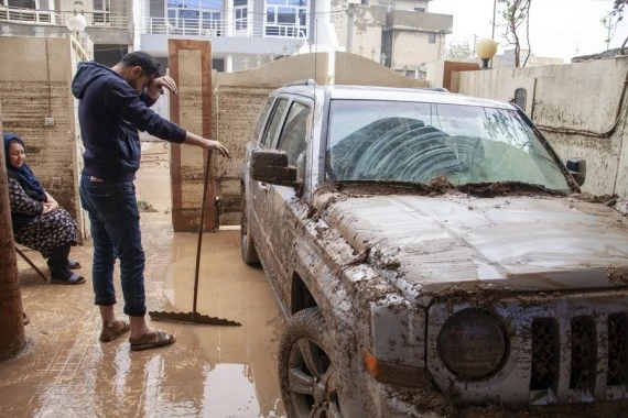 People are seen in an area hit by flash floods in Erbil, northern Iraq, on Dec. 17, 2021. (Photo by Dalshad Al-Daloo/Xinhua)