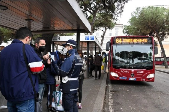 A policeman checks green pass of a passenger at a bus station in Rome, Italy, Dec. 6, 2021.  (Photo by Alberto Lingria/Xinhua)