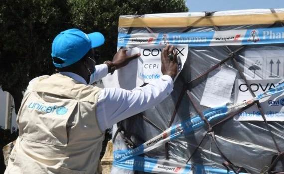 A UN staff member checks a batch of COVID-19 vaccines, as part of the global COVAX initiative, at the Carthage International Airport in Tunis, Tunisia, May 16, 2021. (Photo by Adel Ezzine/Xinhua)