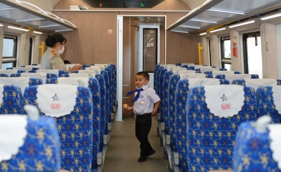 A student from the China-Laos Friendship Nongping Primary School is seen on the Lane Xang EMU train of the China-Laos Railway on Dec. 3, 2021. (Photo by Alan Liu/Xinhua)