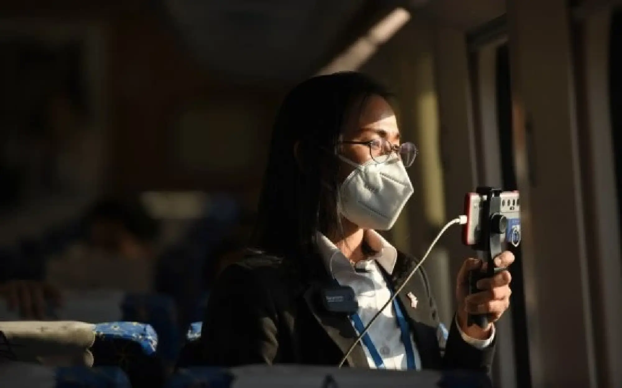 A student from the China-Laos Friendship Nongping Primary School is seen on the Lane Xang EMU train of the China-Laos Railway on Dec. 3, 2021. (Photo by Alan Liu/Xinhua)