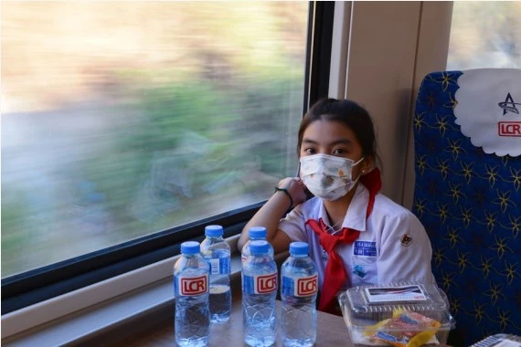 A student from the China-Laos Friendship Nongping Primary School is seen on the Lane Xang EMU train of the China-Laos Railway on Dec. 3, 2021. The China-Laos Railway started operation on Friday. (Photo by Alan Liu/Xinhua)