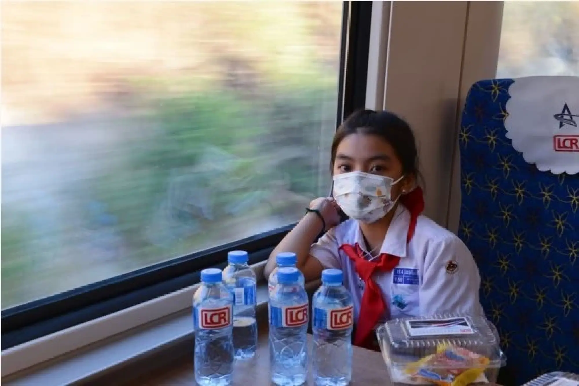 A student from the China-Laos Friendship Nongping Primary School is seen on the Lane Xang EMU train of the China-Laos Railway on Dec. 3, 2021. The China-Laos Railway started operation on Friday. (Photo by Alan Liu/Xinhua)