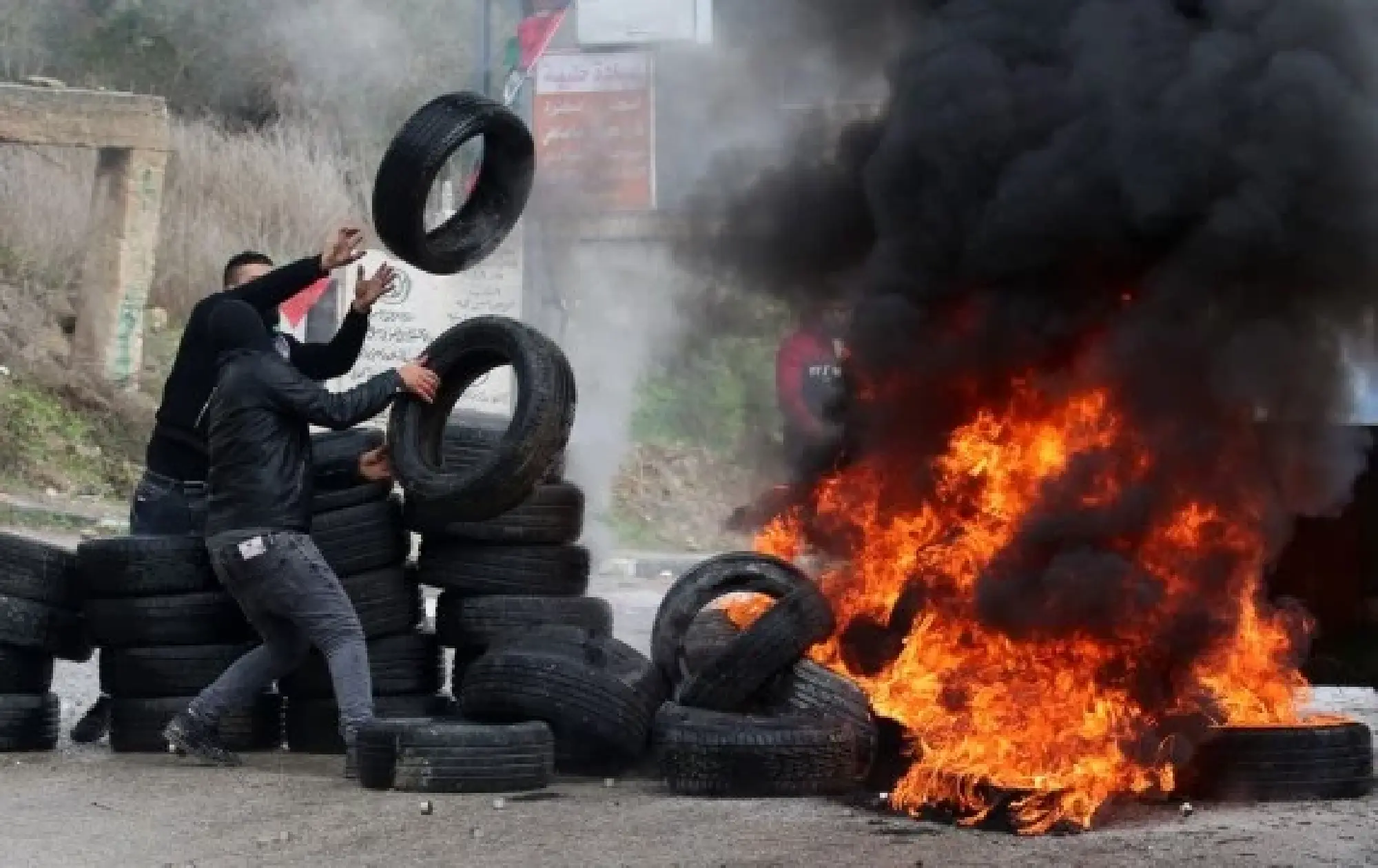 Palestinian protesters burn tires during clashes with Israeli soldiers, in the village of Burqa, north of the West Bank city of Nablus, Dec. 23, 2021. (Photo by Nidal Eshtayeh/Xinhua)