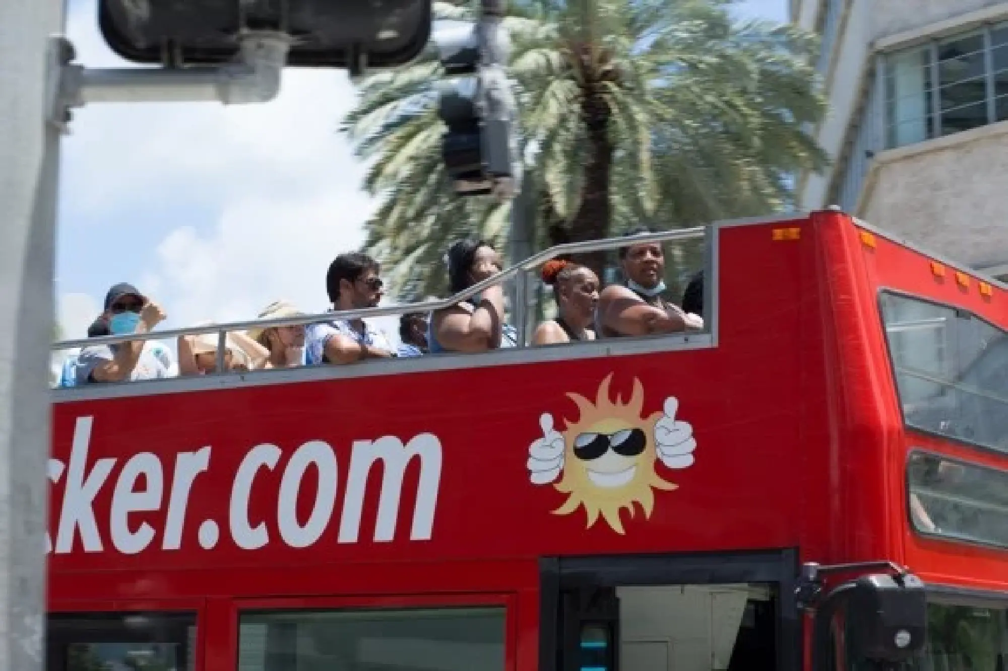 Tourists ride on a double decker bus on Lincoln Road in Miami-Dade County, Florida, the United States, Aug. 6, 2021. (Photo by Monica McGivern/Xinhua)