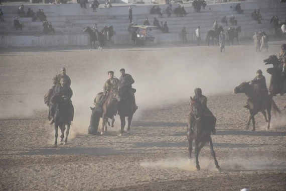 Afghan horse riders compete for a goat during a Buzkashi match in Mazar-i-Sharif, capital of Balkh province, Afghanistan, Dec. 10, 2021. (Photo by Kawa Basharat/Xinhua)