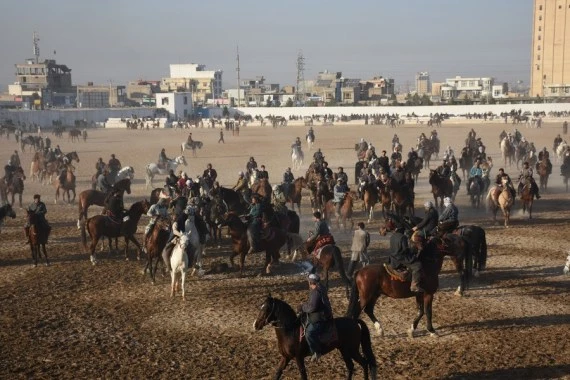Afghan horse riders compete for a goat during a Buzkashi match in Mazar-i-Sharif, capital of Balkh province, Afghanistan, Dec. 10, 2021. (Photo by Kawa Basharat/Xinhua) 