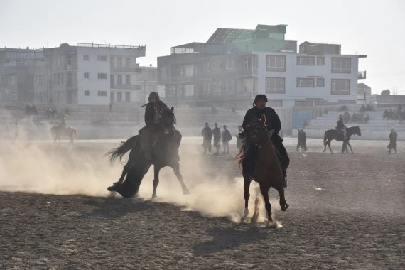 Afghan horse riders compete for a goat during a Buzkashi match in Mazar-i-Sharif, capital of Balkh province, Afghanistan, Dec. 10, 2021. (Photo by Kawa Basharat/Xinhua)
