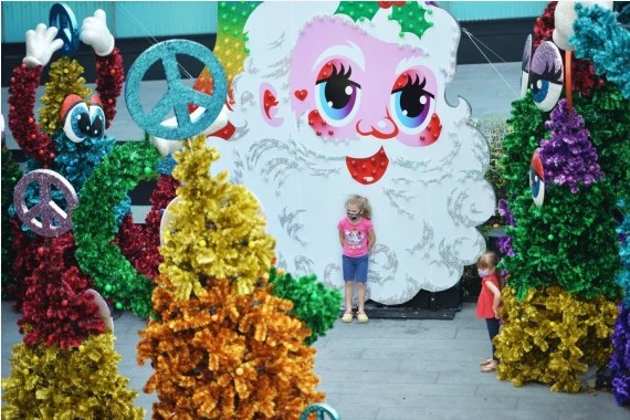 A girl is seen in front of the Christmas decorations at a shopping mall in Bangkok, Thailand, on Dec. 20, 2021. (Xinhua/Rachen Sageamsak)