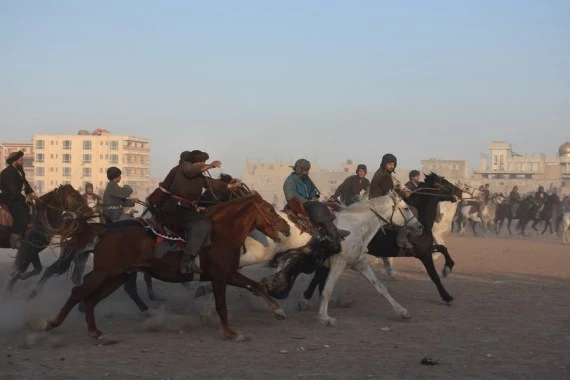 Afghan horse riders compete for a goat during a Buzkashi match in Mazar-i-Sharif, capital of Balkh province, Afghanistan, Dec. 10, 2021. (Photo by Kawa Basharat/Xinhua)