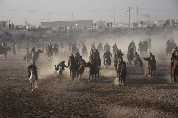 Afghan horse riders compete for a goat during a Buzkashi match in Mazar-i-Sharif, capital of Balkh province, Afghanistan, Dec. 10, 2021. (Photo by Kawa Basharat/Xinhua)