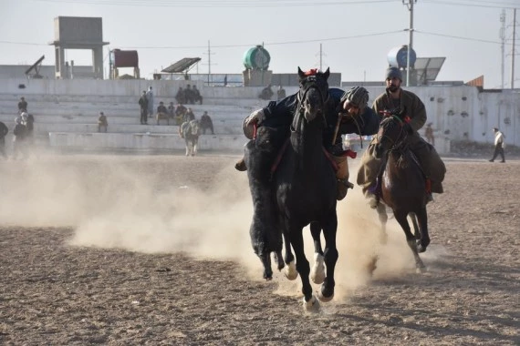 Afghan horse riders compete for a goat during a Buzkashi match in Mazar-i-Sharif, capital of Balkh province, Afghanistan, Dec. 10, 2021. (Photo by Kawa Basharat/Xinhua)