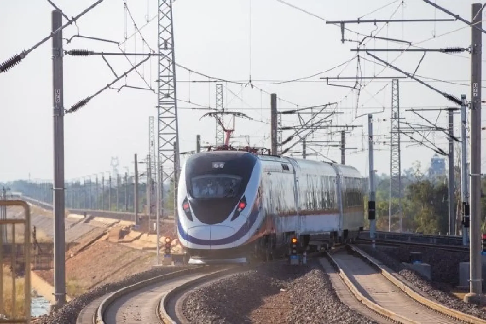 The Lane Xang EMU train of the China-Laos Railway departs from Vientiane Railway Station in Vientiane, Laos, Dec. 3, 2021. (Photo by Kaikeo Saiyasane/Xinhua)