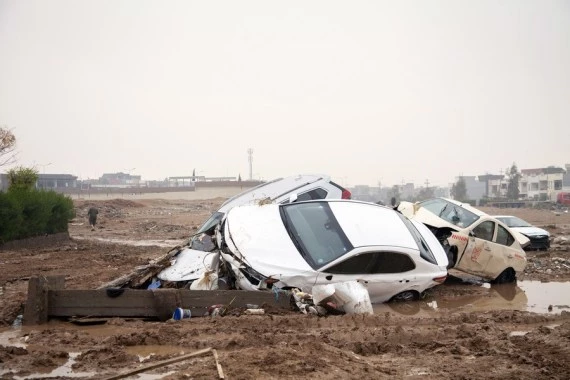 Vehicles are seen damaged in flash floods in Erbil, northern Iraq, on Dec. 17, 2021. (Photo by Dalshad Al-Daloo/Xinhua)