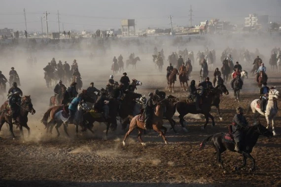 Afghan horse riders compete for a goat during a Buzkashi match in Mazar-i-Sharif, capital of Balkh province, Afghanistan, Dec. 10, 2021. (Photo by Kawa Basharat/Xinhua)