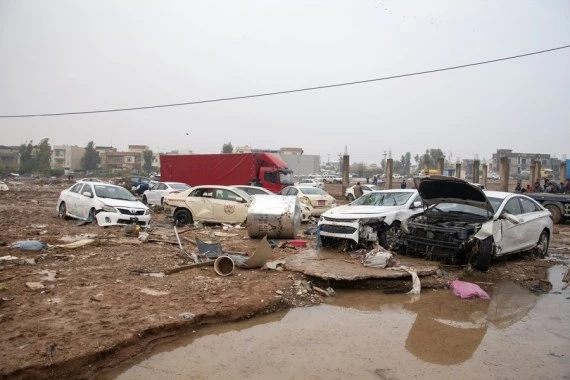 Vehicles are seen damaged in flash floods in Erbil, northern Iraq, on Dec. 17, 2021. (Photo by Dalshad Al-Daloo/Xinhua)