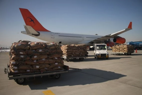 A shipment of pine nuts is seen to be loaded into a plane at Kabul International Airport in Kabul, Afghanistan, on Jan. 10, 2022. (Photo by Saifurahman Safi/Xinhua)