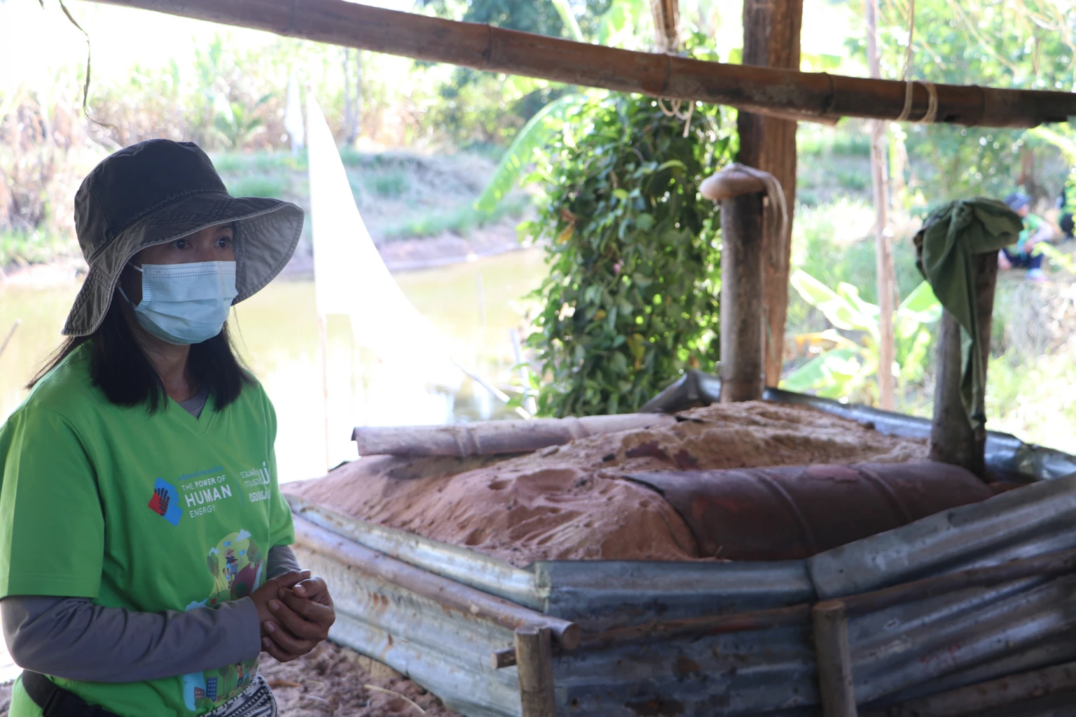 Sunita "Nual" Haewnok, owner of Sa-ngiamkam Agriculture Farm, explains the process for producing wood vinegar at "Khon Aou Than".