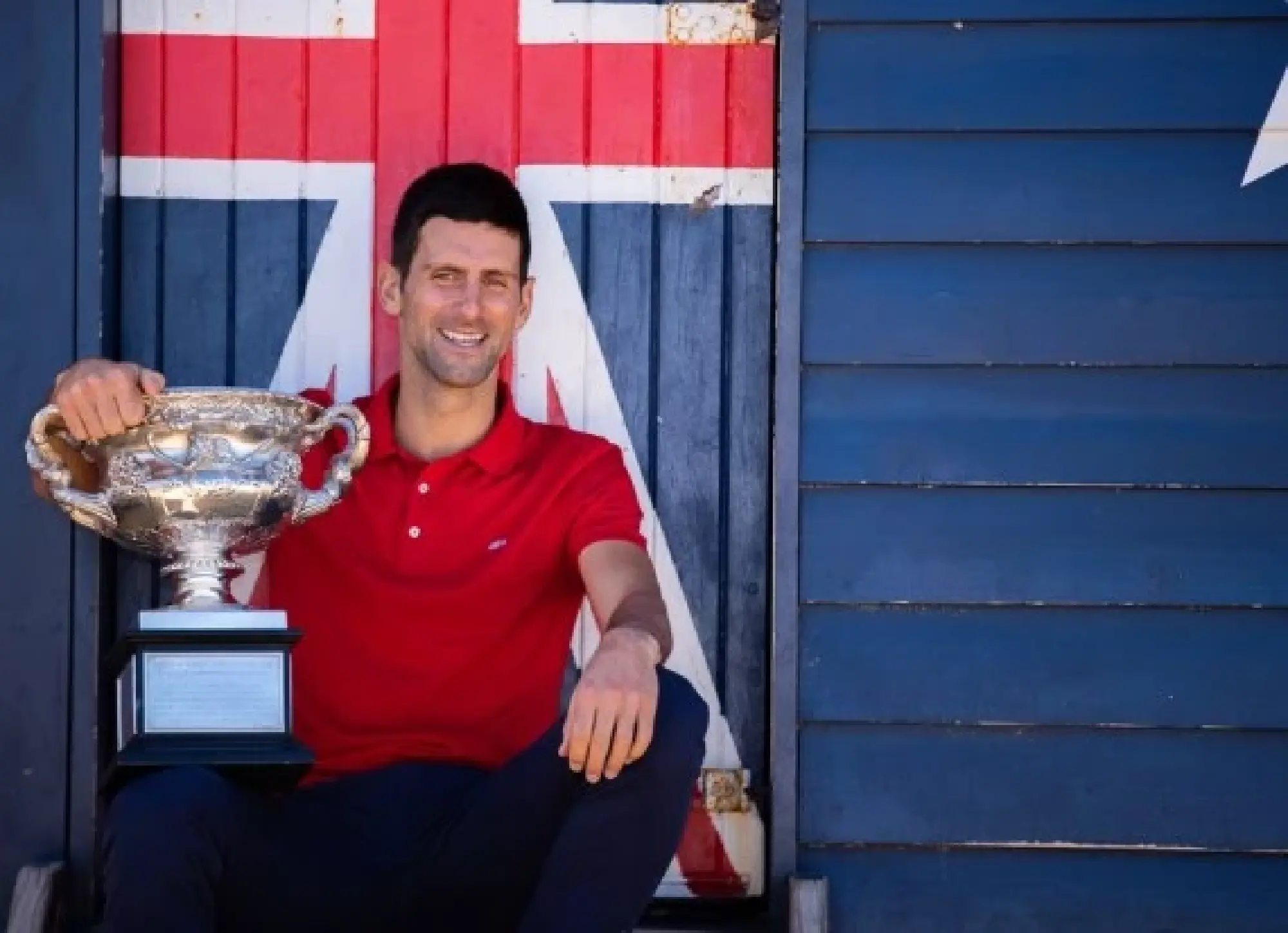2021 Australian Open champion Novak Djokovic poses with champion trophy at Melbourne Brighton Beach, in Melbourne, Australia, Feb. 22, 2021. (Photo by Hu JingChen/Xinhua)