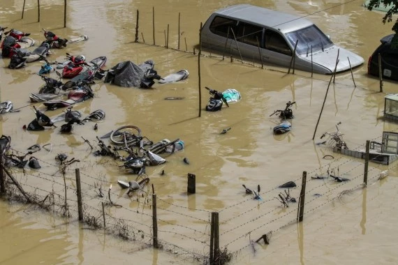 Vehicles are inundated by floodwater in Lhoksukon of Aceh Province, Indonesia, Jan. 4, 2022. (Photo by Fachrul Reza/Xinhua)