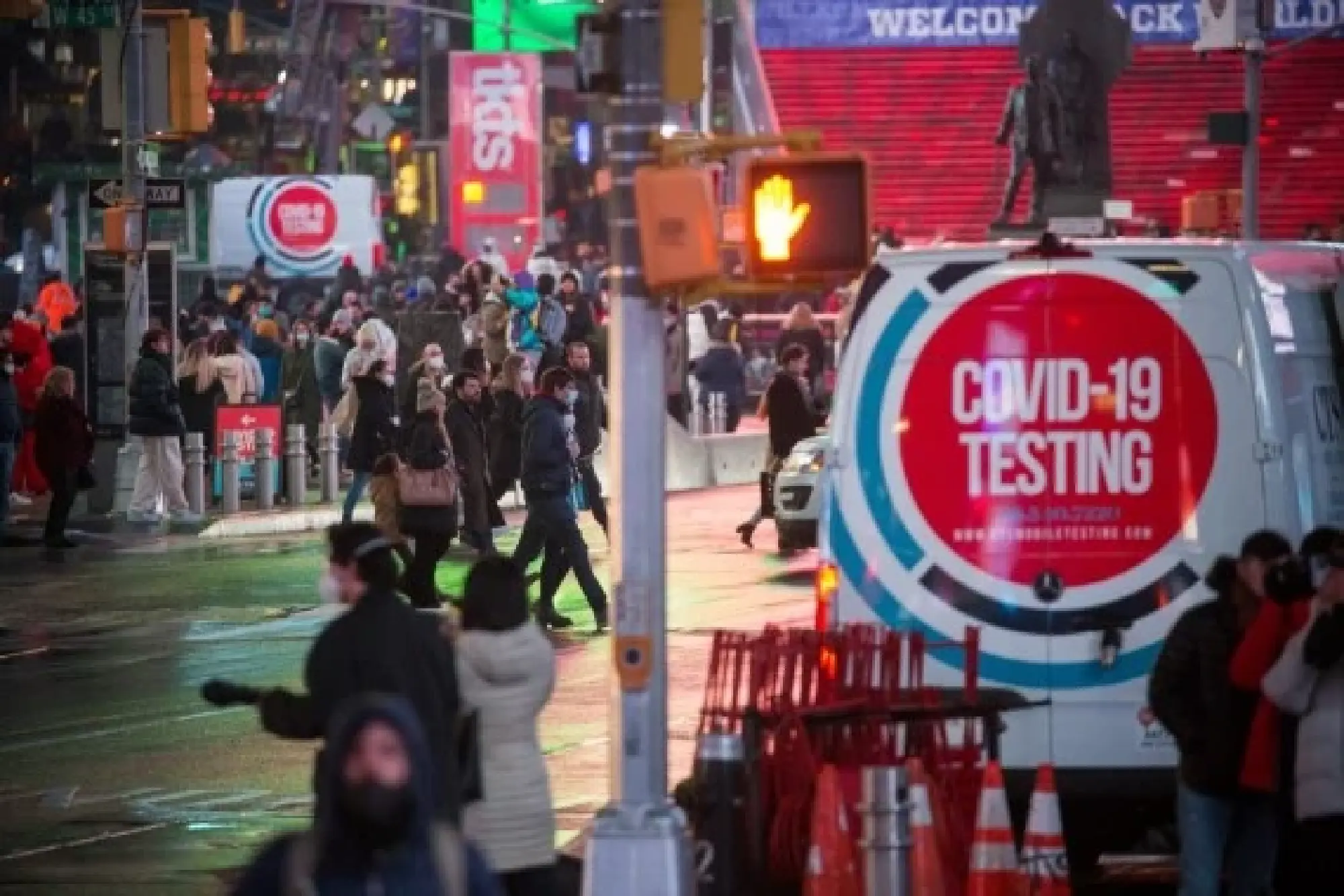 People walk past a COVID-19 testing site in Times Square in New York, the United States, Jan. 9, 2022. (Photo by Michael Nagle/Xinhua)