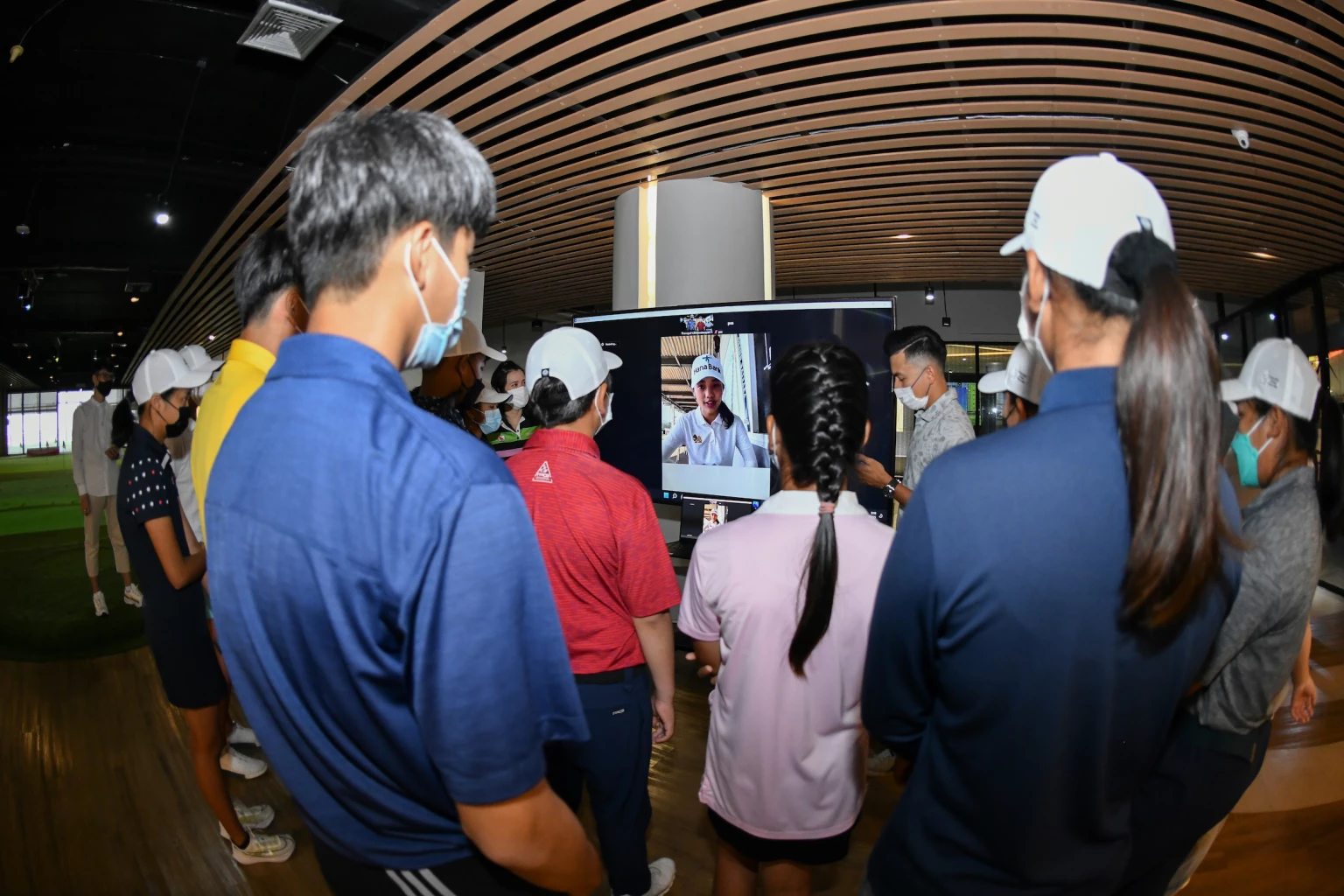 Young and aspiring golf players train with professional golfers at Trust Golf 