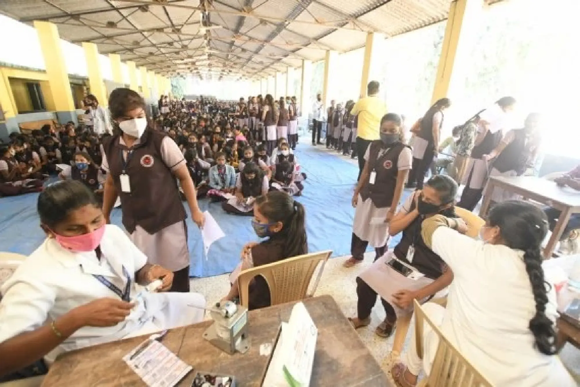 Health workers inoculate students with COVID-19 vaccines in Bangalore, India, Jan. 3, 2022. (Str/Xinhua)