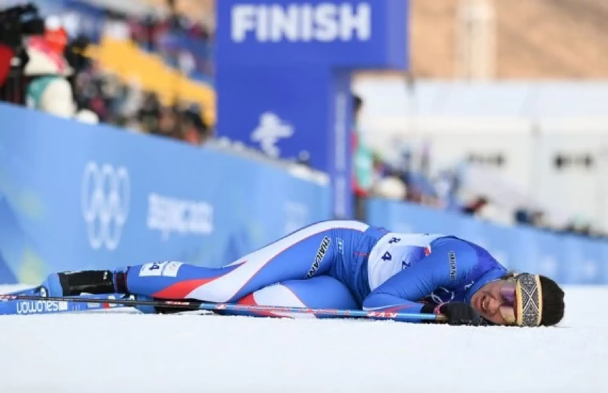 Karen Chanloung collapses after the finish line of the cross-country skiing women's 10km classic at Beijing 2022, Feb. 10, 2022. (Xinhua/Hu Huhu)