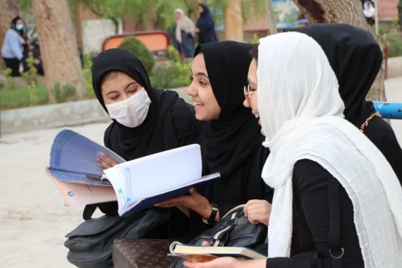 Afghan girls arrive to attend class on the first day of new academic year in Herat city, western Afghanistan, March 23, 2022. (Photo by Mashal/Xinhua)