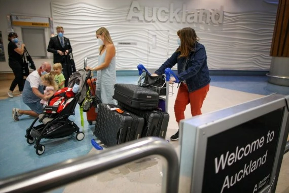 People arrive at International Arrivals of Auckland Airport, New Zealand on Feb. 28, 2022. (Photo by Zhao Gang/Xinhua)