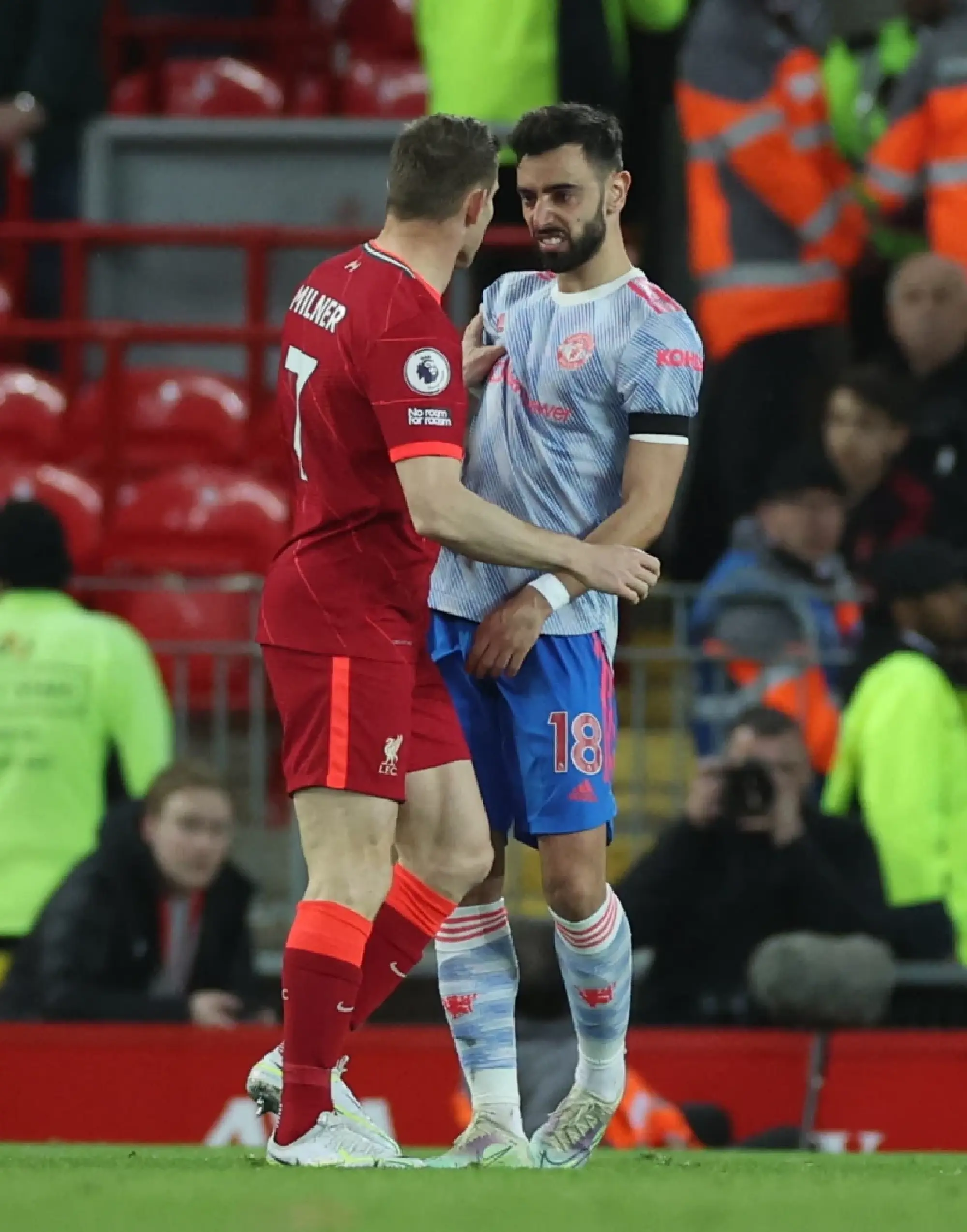 Manchester United's Bruno Fernandes clashes with Liverpool's James Milner REUTERS/Phil Noble