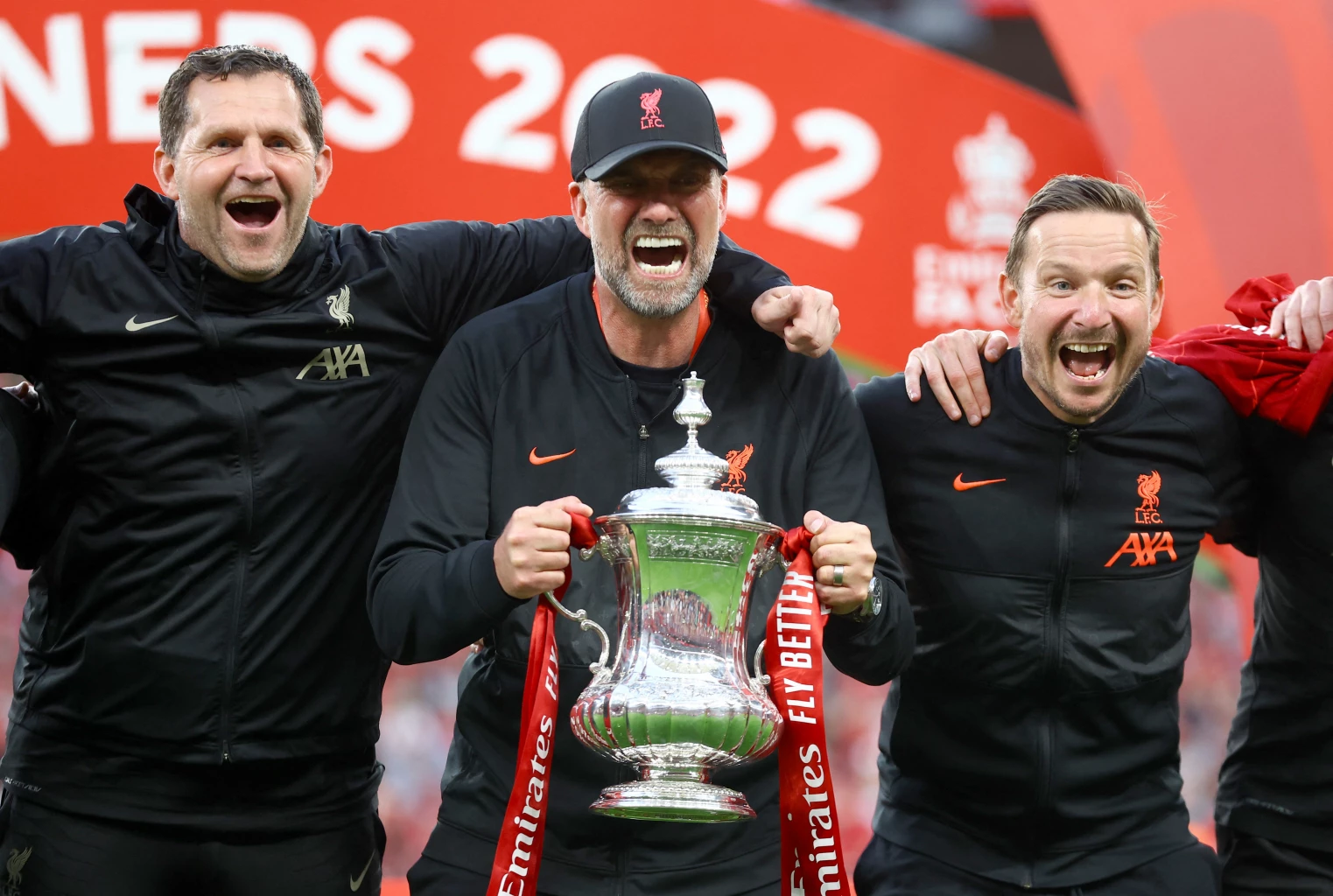 Liverpool manager Juergen Klopp and his coaching team celebrate with the trophy after winning the FA Cup final REUTERS/Hannah Mckay