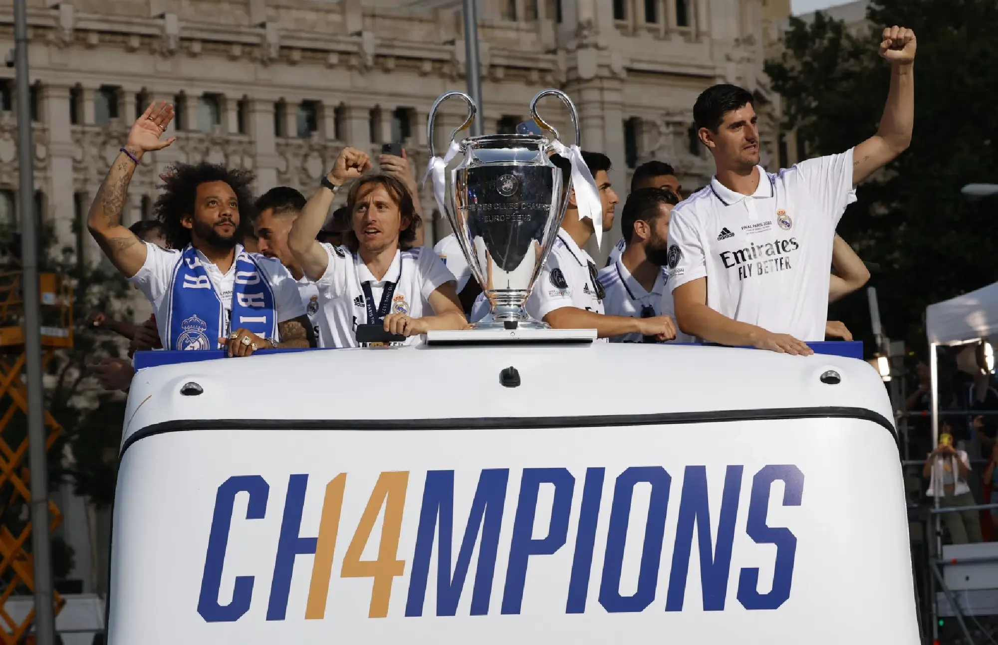 Real Madrid's Thibaut Courtois, Luka Modric and Marcelo celebrate on an open top bus with the Champions League trophy during the victory parade REUTERS/Marcelo Del Pozo