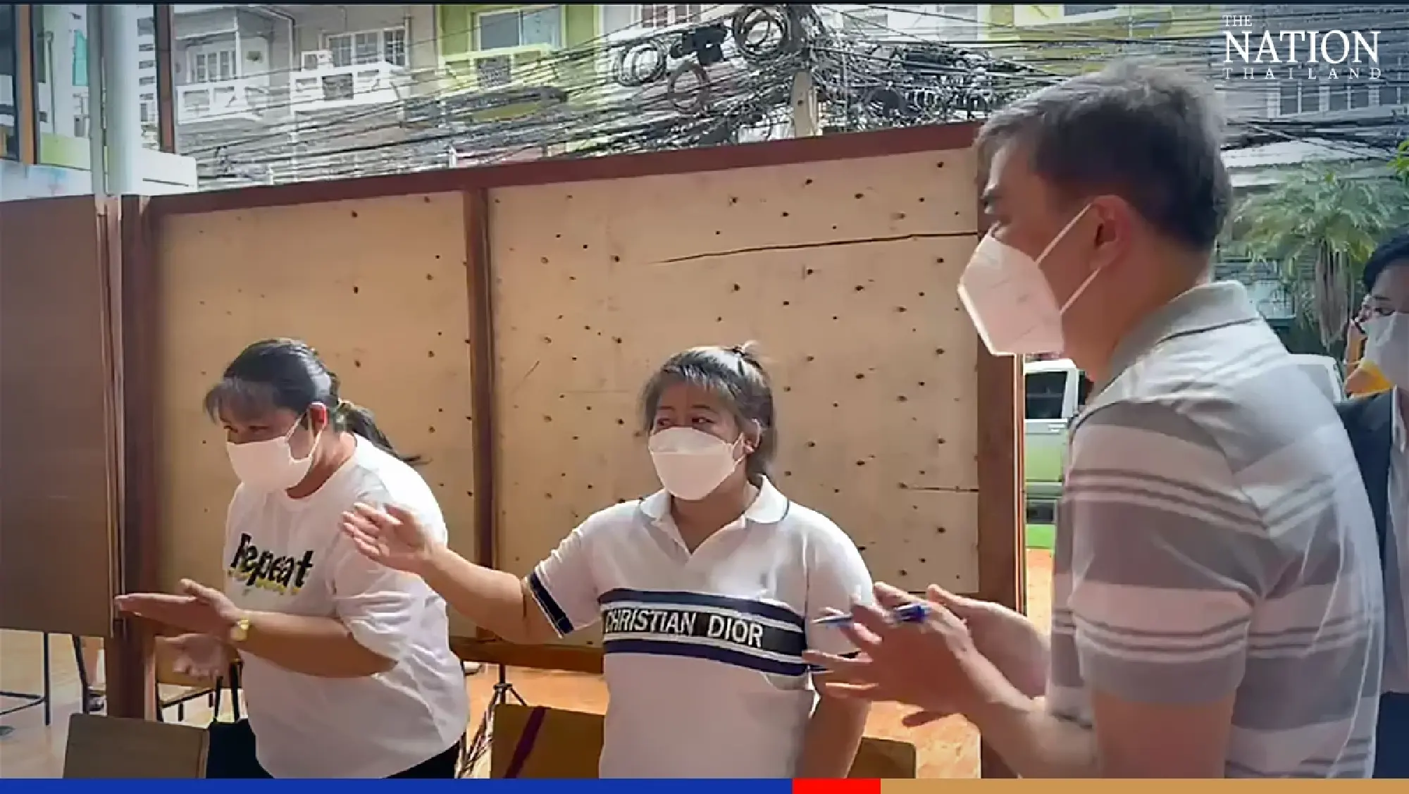 Former Democrat leader Abhisit braves rain to vote on Sukhumvit