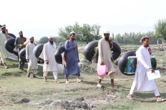 Local teachers cross a river by leather rafts to get to school in Nangarhar province, Afghanistan, June 11, 2022. (Photo by Hamidullah/Xinhua)