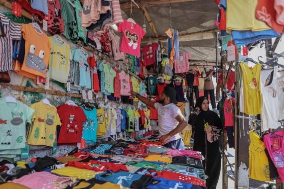A Palestinian woman shops at a market ahead of the Eid al-Adha festival in Gaza City, July 5, 2022. (Photo by Rizek AbdeljawadXinhua)